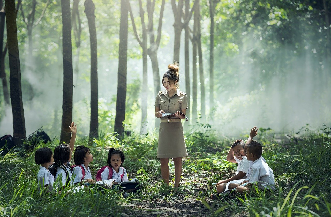 森の中で子どもたちに授業をする先生